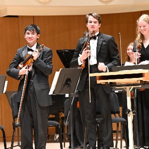 Musicians smiling at the applause received following their performance