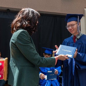 Graduate accepts diploma from Superintendent Haberer