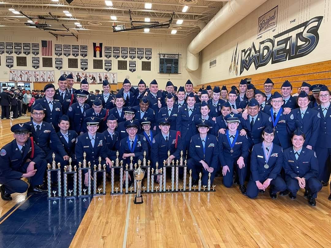 D20 JROTC Drill Team poses with trophies 