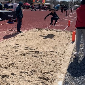 Student jumping to the longjump pit