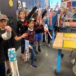 Students holding their homemade windsocks.