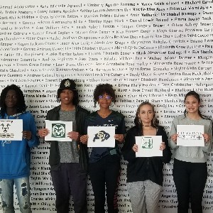 AVID students holding signs with the logo of the college they will attend in the fall, part 2