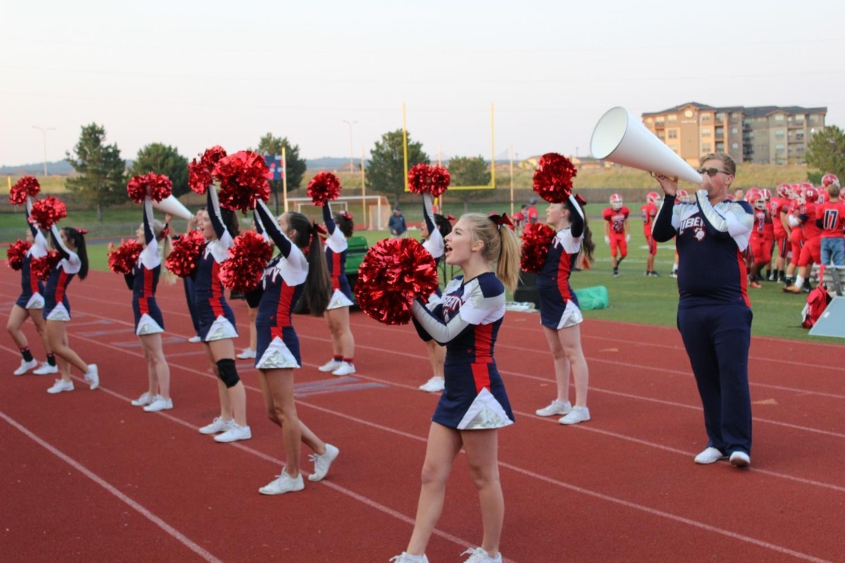 The Liberty cheer team performs on the field.