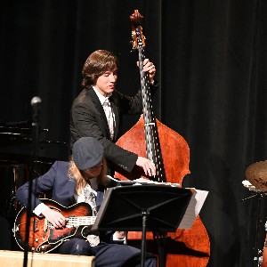 One student playing a stand-up bass and another an electric guitar