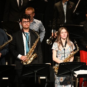 Three students standing with saxophones