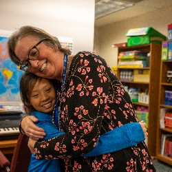 Carina Raetz hugs her student goodbye before leaving her class