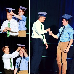 The Livergood brothers placing graduation caps on each other's heads.