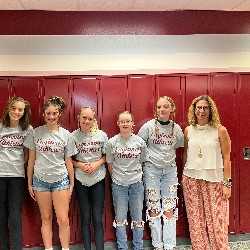 Students wearing the Eagleview Athletics t-shirts stand with Mrs. White in front of lockers.