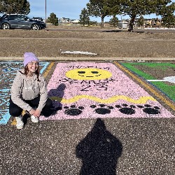 Parking spot painted with smiley face and the word "Senior"