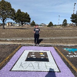 Parking spot painted with the word Kate