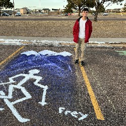 Parking spot painted with mountains and a skiier