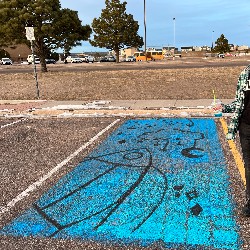 Parking spot painted with a cloud and stars