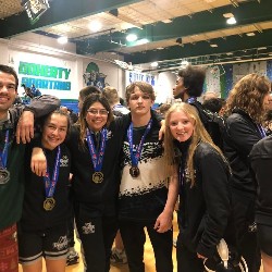 Wrestlers pose with medals