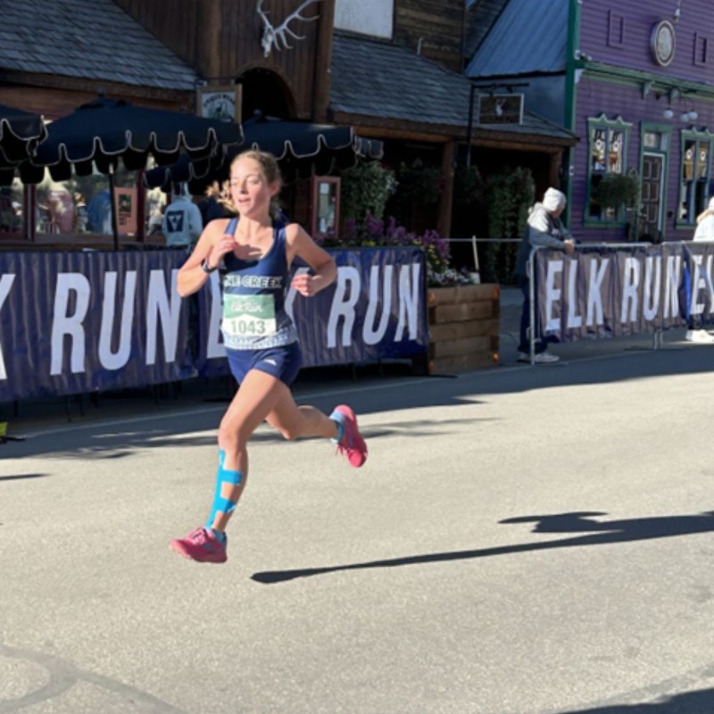 Girl running cross country race