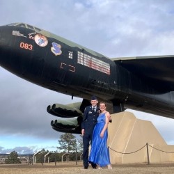 Anna Cummins and Hayden Shaffer in front of the B-52 Fortress before the ball.