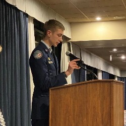 Ryan Wendt introduces his father, Col. Wendt, as the guest speaker.