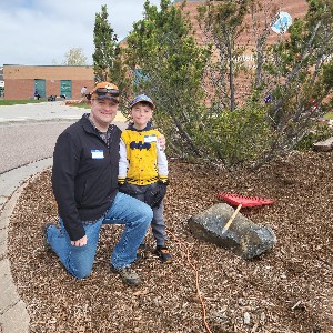 Father and son spreading mulch