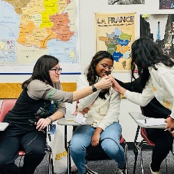 Students put hands together before State competition