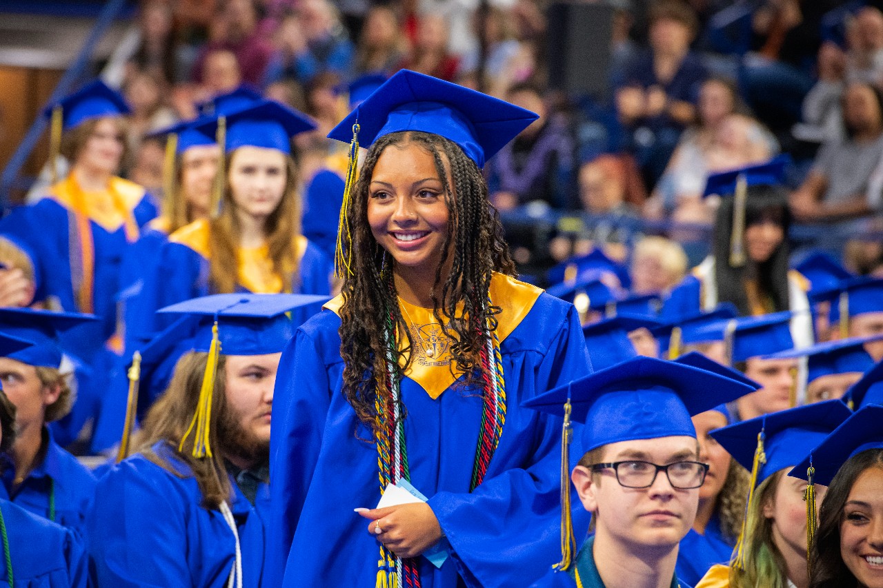 a student smiling at graduation