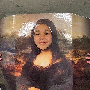 Student "wearing" the Mona Lisa by sticking their head through a cutout