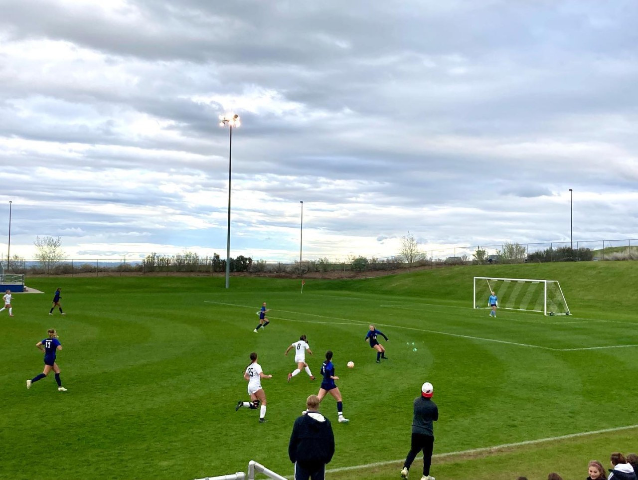 Soccer players engaged in Game on Field