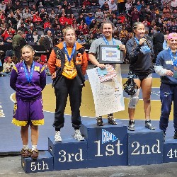 Female wrestlers on podium after competition