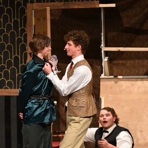 Actor holding fellow castmate by the collar