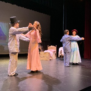 The Darling family dancing on stage.