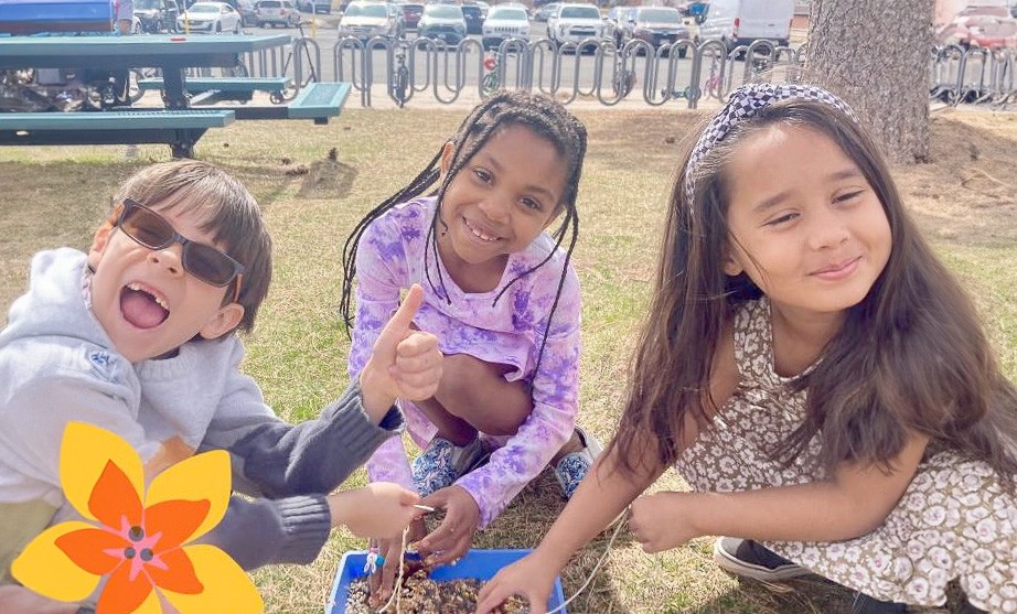 Three students doing experiments outside.