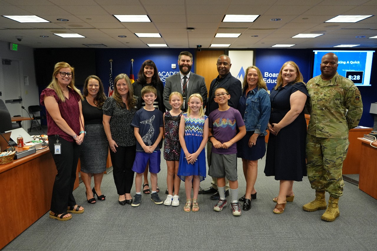 Board of Education members, D20 staff and students smile for a photo