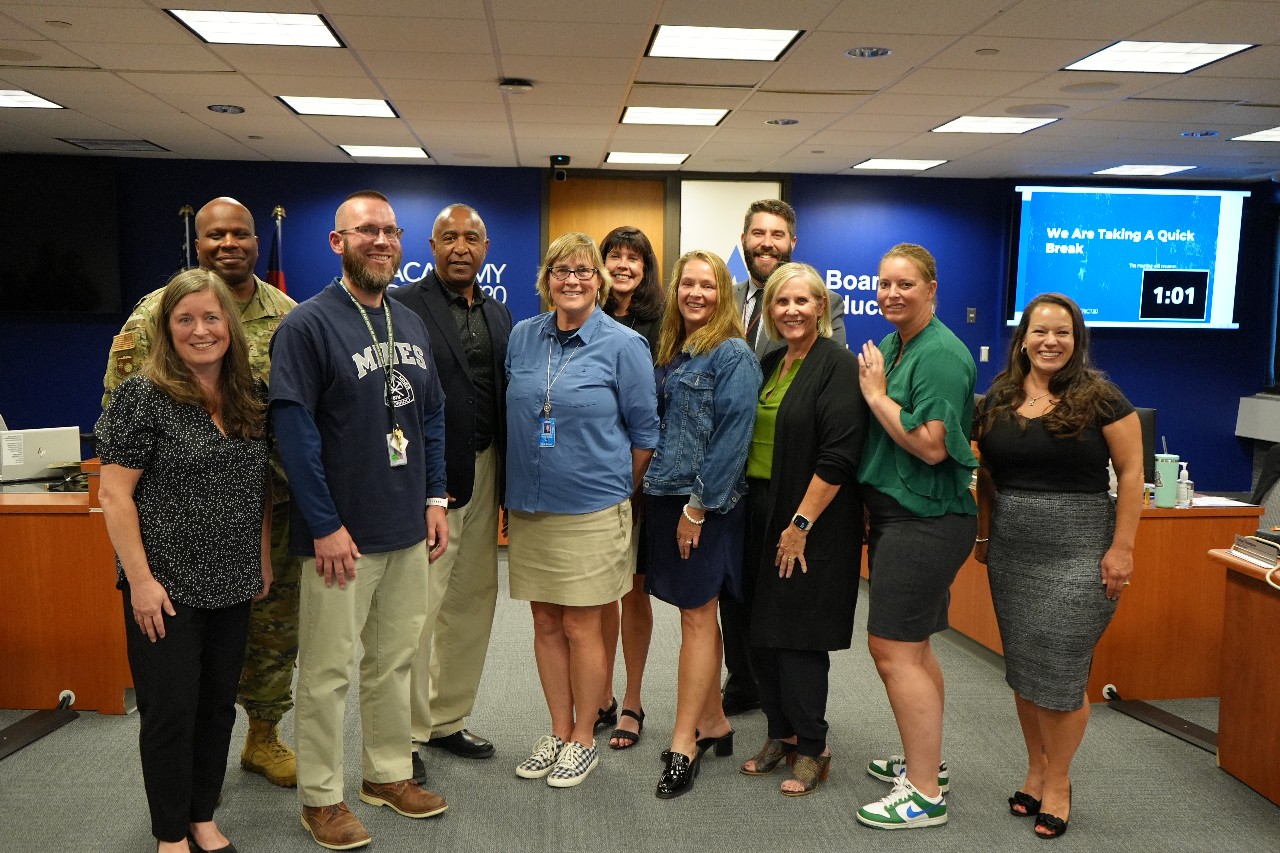 D20 Board of Education, Superintendent smile for a photo with Pine Creek High School staff