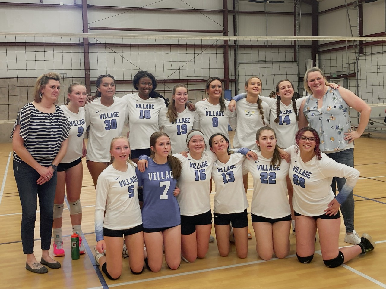 A group photo of the Village Girls Volleyball Team