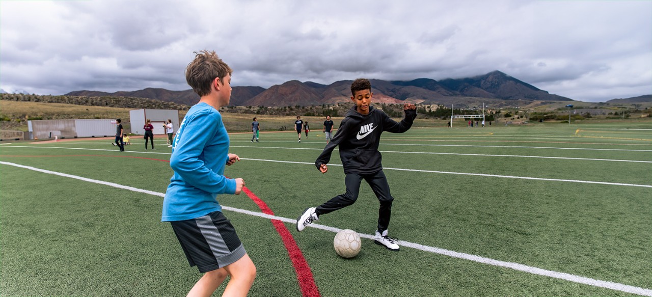 Two Eagleview Middle School students practice soccer on the field.