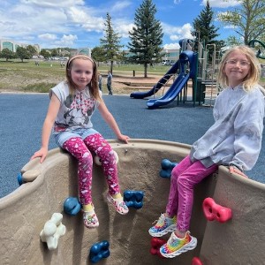 Kids sit on rock wall