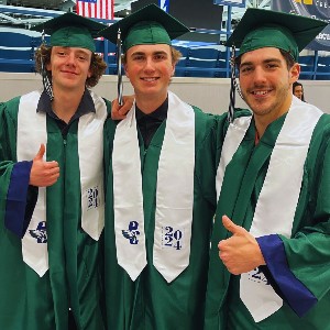 Three boys in graduation robes