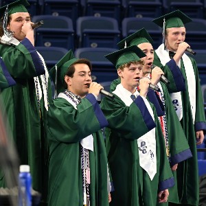 Group of boys singing in Graduation robes