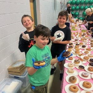 Student leaders serve a breakfast of donuts.