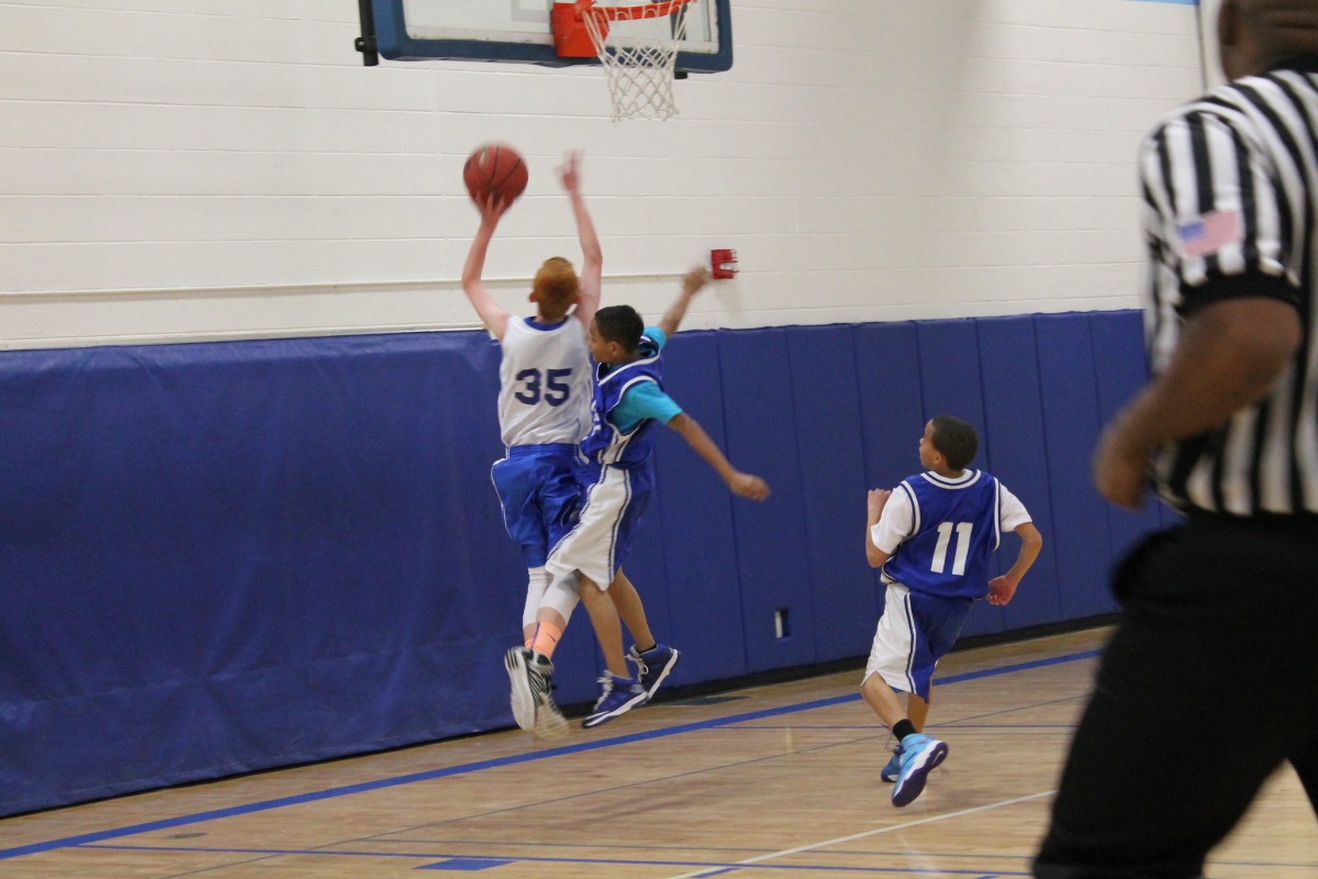 A TMS basketball player throwing the ball during a game.