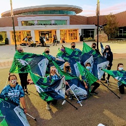 The PCHS Color Guard team poses in front of their school.