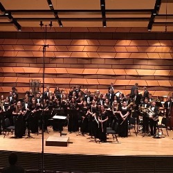 The PCHS Orchestra performs on stage.