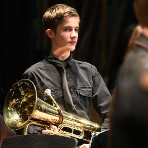 Student holding baritone