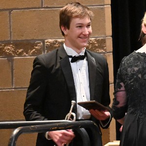 Student holding trumpet and smiling