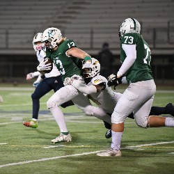 #13 running down the field with player from Legacy about to tackle him