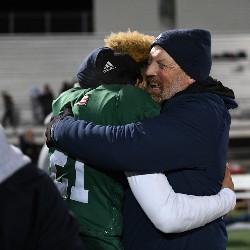 Coach hugs player after winning the game