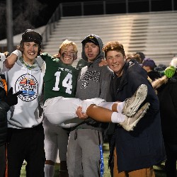 Classmates hold player #14 in celebration after the game