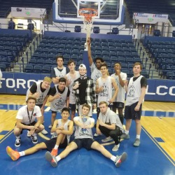 The PCHS mens basketball team poses with a trophy.