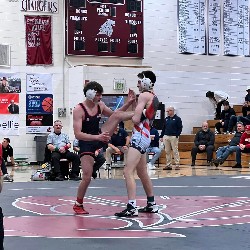 Wrestler holding his opponent's leg in the air after the opponent attempted to kick him