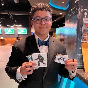 Student holding up giftcards