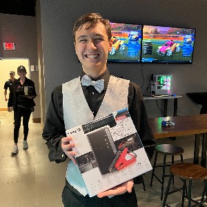 Student holding up his raffle prize