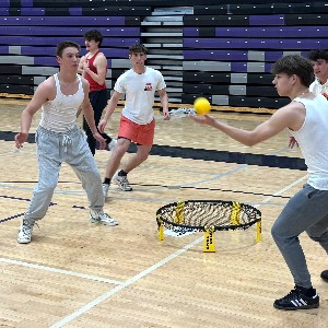 Spikeball player preparing to hit the ball